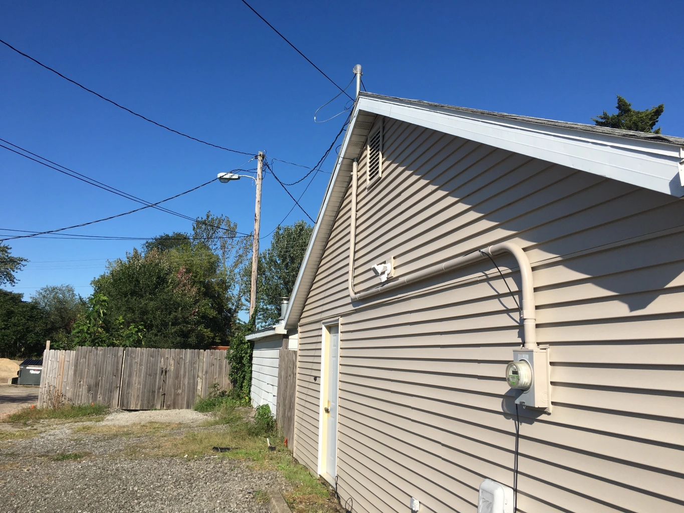 A house with power lines on the side of it.