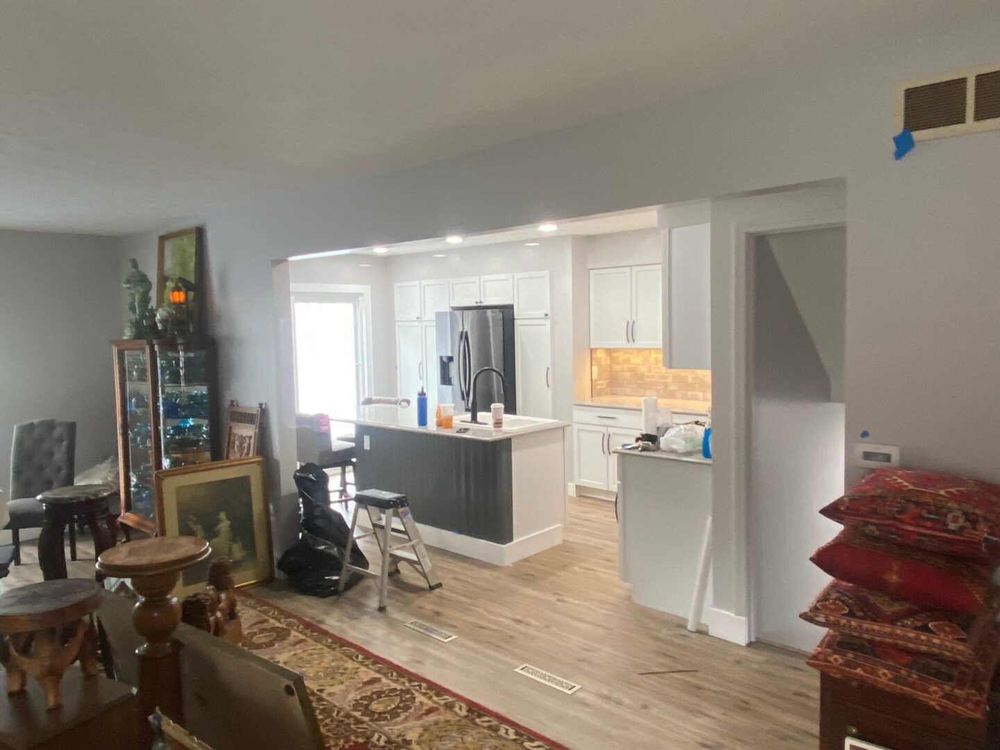 kitchen with white interiors and wooden flooring